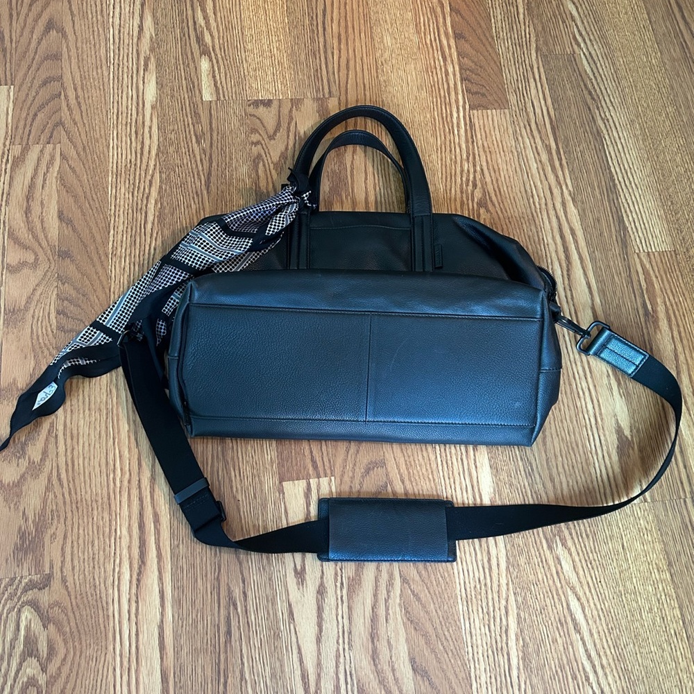 Black AWAY Duffel Bag with Adjustable Strap and Minimalist Design